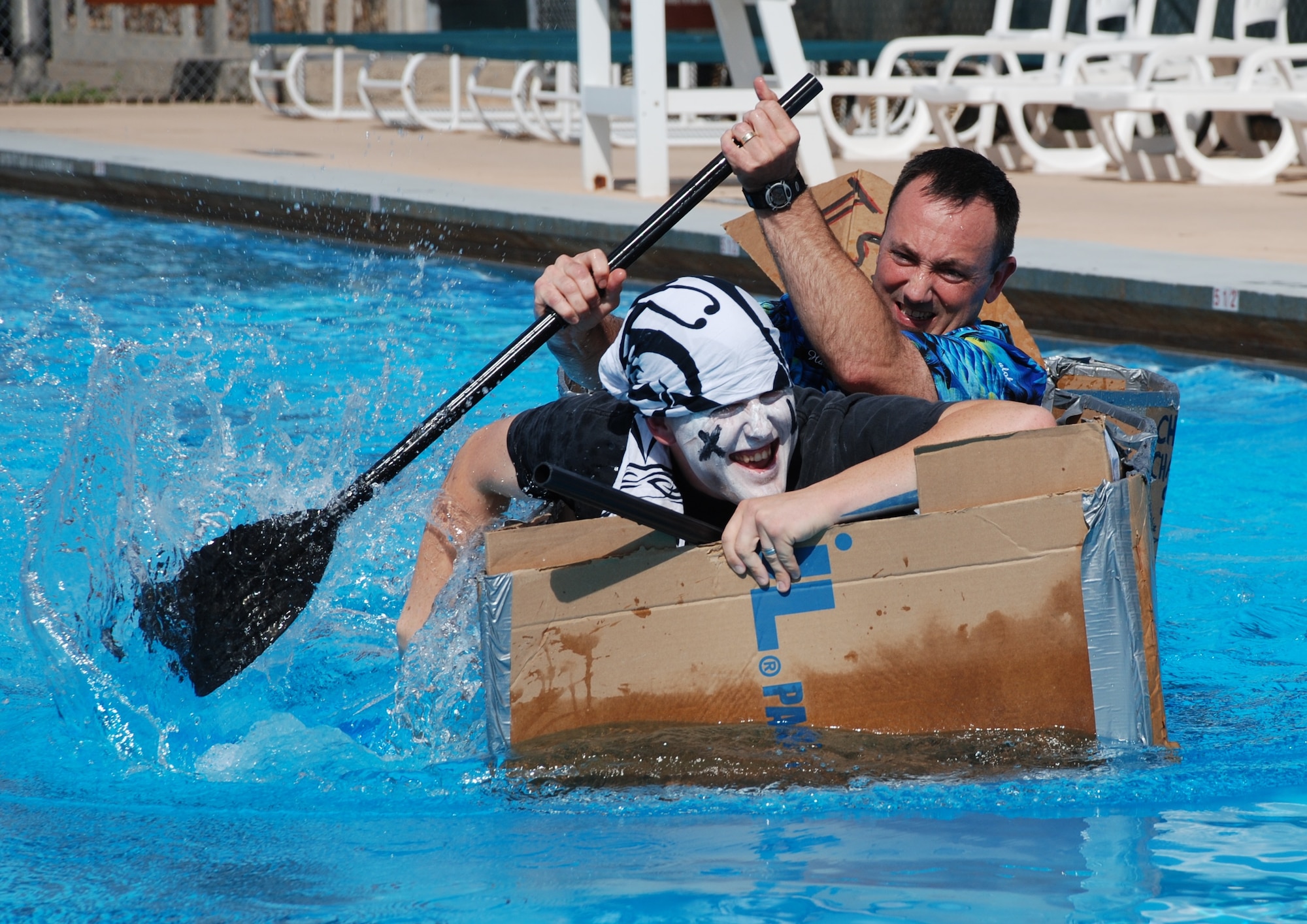 LAUGHLIN AIR FORCE BASE, Texas – Maj. Dwayne Keener, 47th Flying Training Wing chaplain, and Staff Sgt. Anthony Gray, 47th FTW chapel, compete in the 2010 Laughlin Build-a-Boat Race at Friendship Pool here Sept. 2. The chapel team was awarded best boat design by the judges. Competitors were given single-ply cardboard and duct tape as supplies to build their boat and allowed to use nothing else. (U.S. Air Force photo by Airman 1st Class Blake Mize)