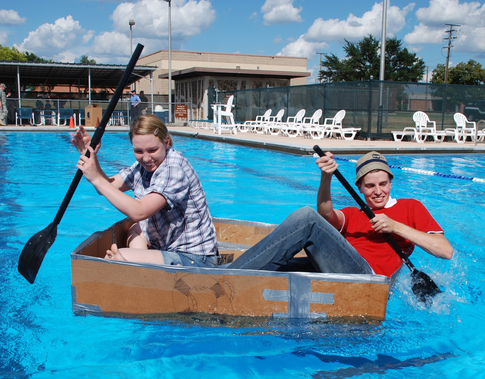 LAUGHLIN AIR FORCE BASE, Texas – Second Lt. Miles Morse and Staff Sgt. Desiree Economides, both of 47th Flying Training Wing public affairs, compete in the 2010 Laughlin Build-a-Boat Race at Friendship Pool here Sept. 2. The PA boat was the only one to remain intact after two full races. Competitors were given single-ply cardboard and duct tape as supplies to build their boat and allowed to use nothing else. (U.S. Air Force photo by Airman 1st Class Blake Mize)
