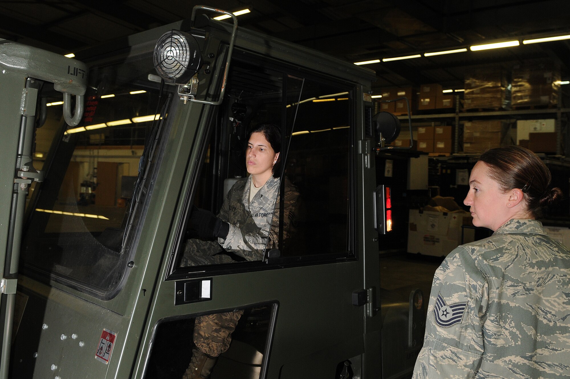 ZEMMER, Germany – Tech. Sgt. Sheryl Neisner, 52nd Medical Support Squadron NCO in charge of medical war reserve material, guides Staff Sgt. Alexandra Holley, 52nd MDSS war reserve material crew chief, as she moves medical supplies on a forklift at a warehouse  in Zemmer Sept. 1. The 14,000 square foot storage facility stores medical war reserve material used during wartime and humanitarian efforts. (U.S. Air Force photo/Senior Airman Nick Wilson)