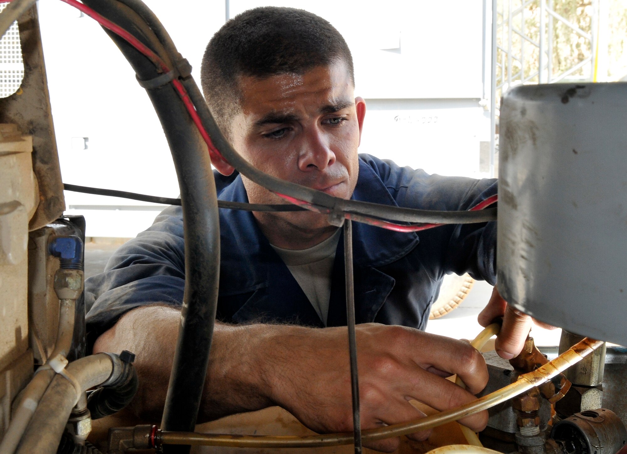 Airman 1st Class Damien Debar, 332nd Expeditionary Maintenance Squadron aerospace ground equipment journeyman, performs a service inspection on a portable air compressor Sept. 1, 2010, Joint Base Balad, Iraq. One of the uses of the air compressor is to pressurize aircraft-fuel tanks to check for leaks. Airman Debar is a native of Fallon, Nev., deployed from Mountain Home Air Force Base, Idaho. (U.S. Air Force photo/Staff Sgt. Phillip Butterfield)