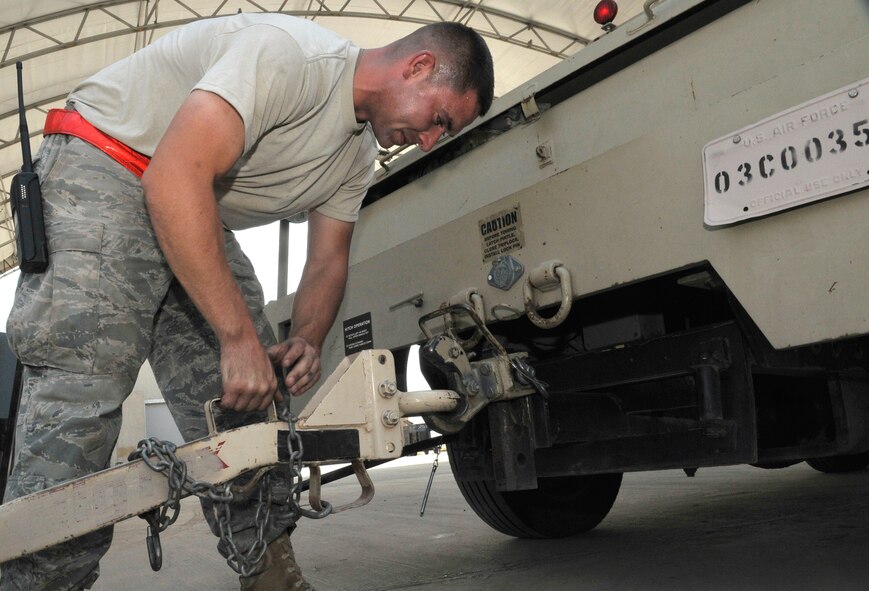 Senior Airman Justin Raines, 332nd Expeditionary Maintenance Squadron aerospace ground equipment journeyman, hooks an equipment trailer to a bobtail truck to move non-powered AGE from the ready line to the flightline Sept. 1, 2010, Joint Base Balad, Iraq. The Bobtail truck, a short- heavy vehicle with a utility box as a bed, is the primary vehicle used to pull pieces of AGE equipment around the flightline. Airman Raines is a native of Oklahoma City, Okla. deployed from Little Rock Air Force Base, Ark. (U.S. Air Force photo/Staff Sgt. Phillip Butterfield)