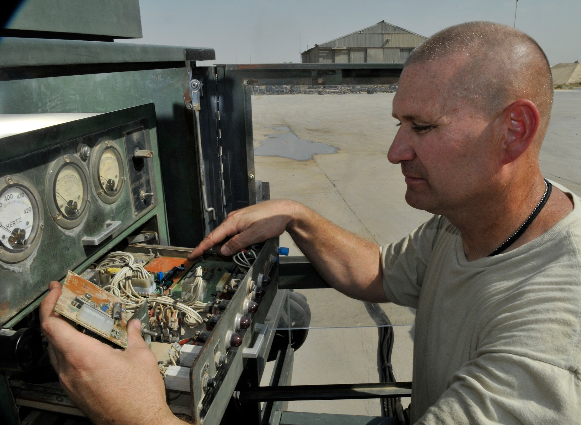 Tech. Sgt. Michael Eads, 332nd Expeditionary Maintenance Squadron aerospace ground equipment craftsman, compares part numbers on a voltage card for compatibility on a gas generator Sept. 1, 2010, Joint Base Balad, Iraq. The Hobart generator is a piece of equipment used to supply power to aircraft when the engine is not running. Sergeant Eads is a native of San Antonio, Texas, deployed from Shaw Air Force Base, S.C. (U.S. Air Force photo/Staff Sgt. Phillip Butterfield)