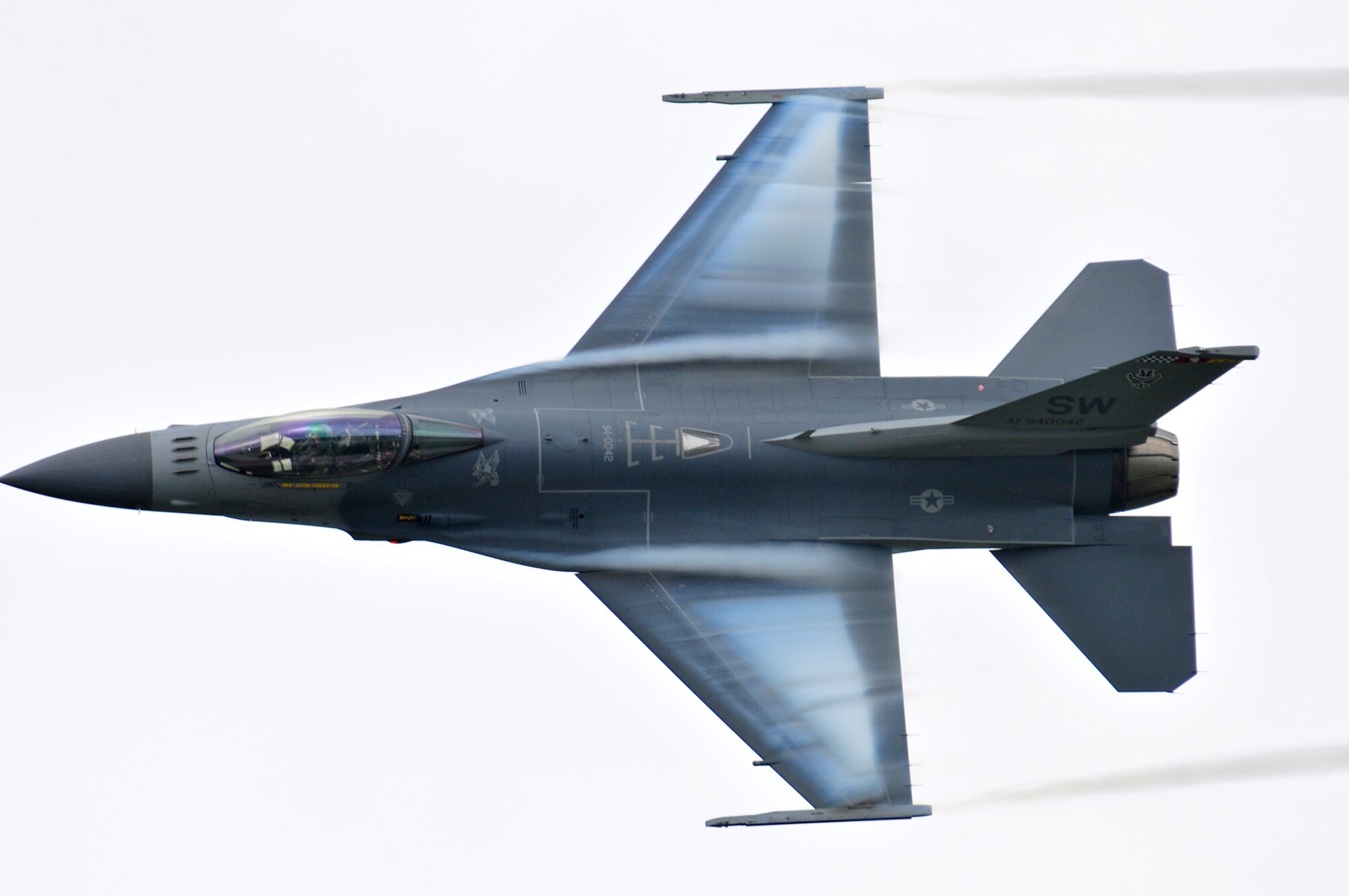 Viper East F-16 Demo Pilot pulling vapor on his dedication pass, at Volk Field Open House, 21 Aug 2010.  (U.S. Air Force photo courtesy Joe Oliva) (RELEASED).