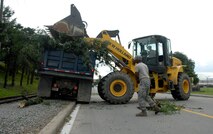 51st Civil Engineer Squadron crews work to clear the streets by clearing power lines, roadways and sidewalks of debris at Osan Sept. 2. Many crews worked throughout the day and night to return hazardous road conditions to normal following Typhoon Kompasu. (U.S. Air Force photo/Senior Airman Evelyn Chavez)