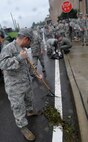 51st Fighter Wing Airmen remove tree branches from parking lots and streets Sept. 3. Airmen from Osan volunteered to help clean up the debris caused by Typhoon Kompasu. (U.S. Air Force photo/Senior Airman Evelyn Chavez)