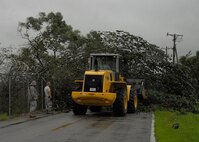 51st Civil Engineer Squadron crews work to clear the streets by clearing power lines, roadways and sidewalks of debris at Osan Sept. 2. Many of the crews worked throughout the day and night to return hazardous road conditions to normal following Typhoon Kompasu. (U.S. Air Force photo/Senior Airman Evelyn Chavez)