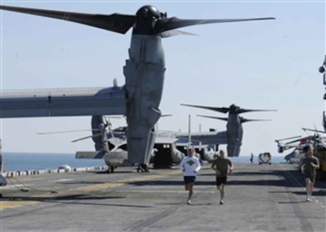 U.S. Marines run on the flight deck aboard the amphibious assault ship USS Kearsarge (LHD 3) on Aug. 29, 2010.  The Kearsarge is en route to Pakistan to provide relief to flood-stricken regions of the country.  