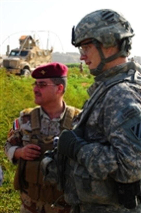 U.S Army Lt. Col. Richard Coffman (right), commander of 3rd Squadron, 7th Cavalry Regiment, 2nd Heavy Brigade Combat Team, 3rd Infantry Division, meets with an Iraqi army commander in Mosul, Iraq, on Aug. 25, 2010.  