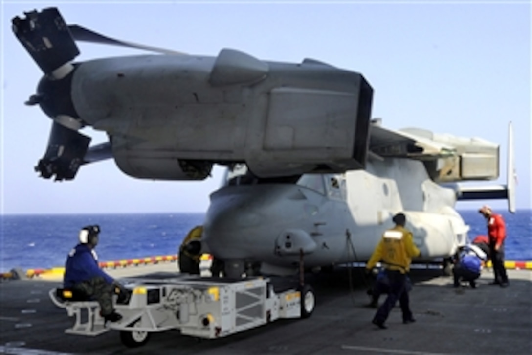 U.S. Navy sailors move an MV-22 Osprey onto the aircraft elevator of the amphibious assault ship USS Kearsarge in the Atlantic Ocean, Sept. 2, 2010. The Kearsarge Amphibious Ready Group is en route to Pakistan to help provide relief to flood-stricken regions.