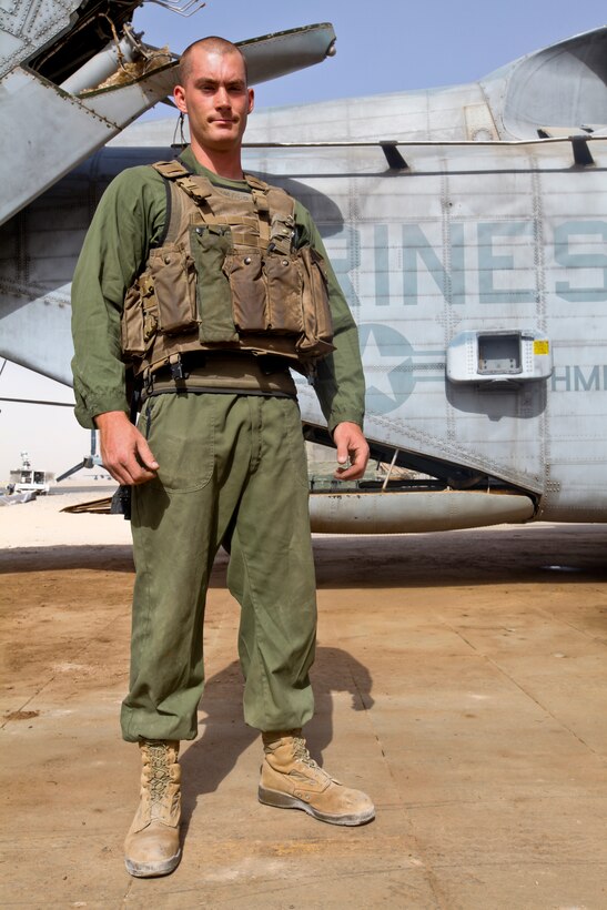 Lance Cpl. Jeffrey Wyman, a flight equipment technician with Marine Heavy Helicopter 361, 3rd Marine Aircraft Wing (Forward), demonstrates how the new Micro Climate Cooling Unit System looks when worn over the flight suit and under flight equipment outside his squadron's hangar on the flight line here Sept. 4. HMH-361 is the first squadron to use the new vest in a combat zone.