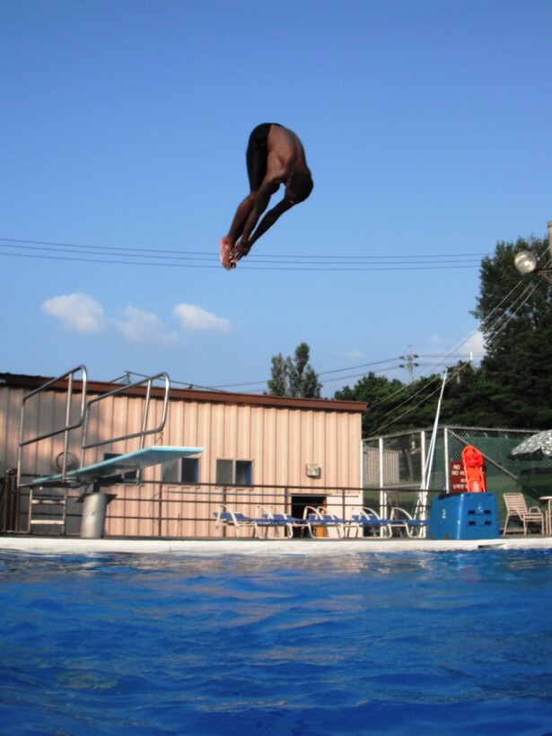 Kenith Isreal dives in at Osan’s Defender Pool Sept. 4. The outdoor pool complex remains open through Sept. 7; after that, members of the Team Osan community can swim year-round at the Mustang Indoor Pool. For hours and information, call 784-1452. (U.S. Air Force photo/Staff Sgt. Eric Burks)