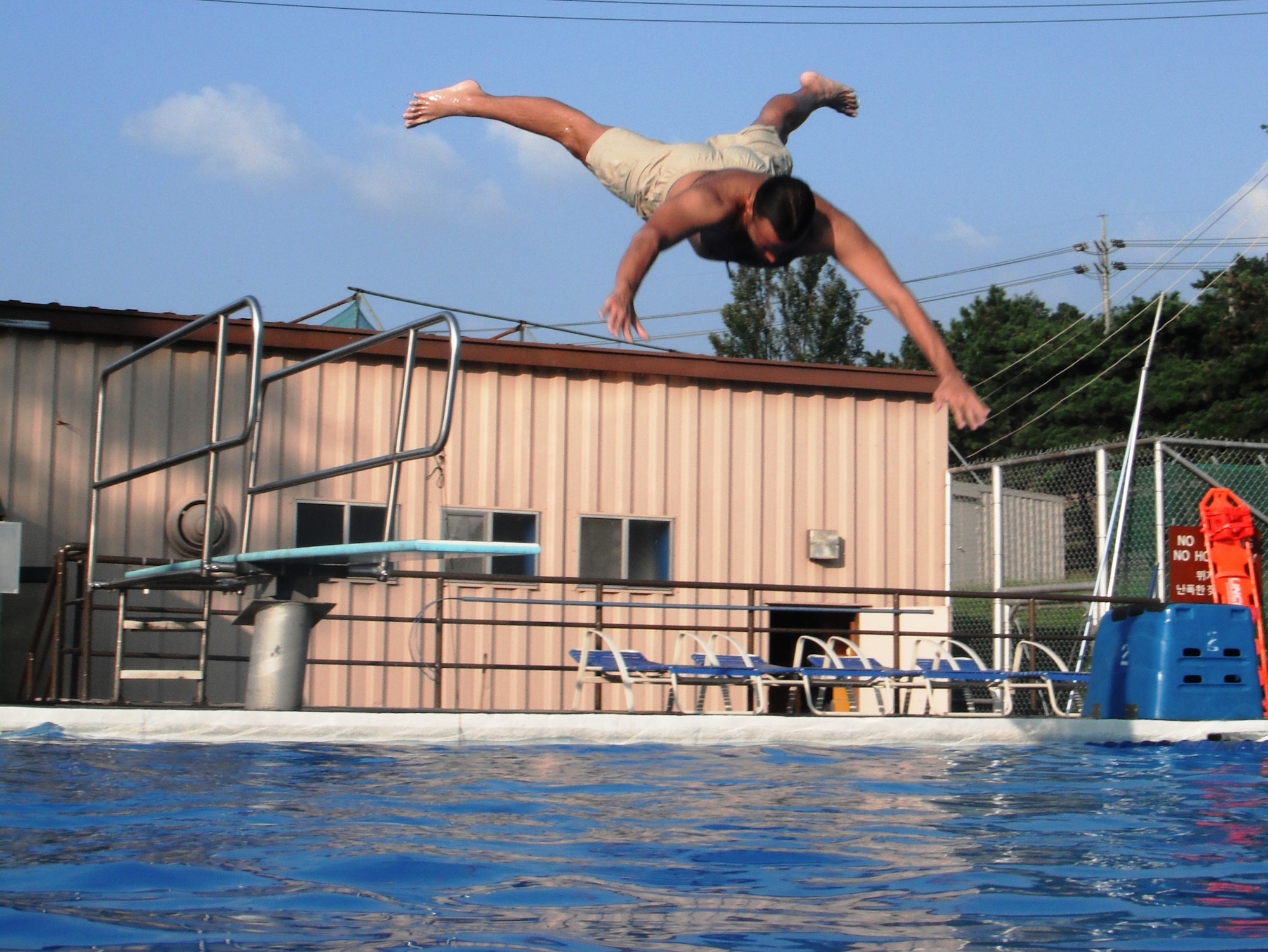 Justin Sieffert dives in at Osan’s Defender Pool Sept. 4. The outdoor pool complex remains open through Sept. 7; after that, members of the Team Osan community can swim year-round at the Mustang Indoor Pool. For hours and information, call 784-1452. (U.S. Air Force photo/Staff Sgt. Eric Burks)
