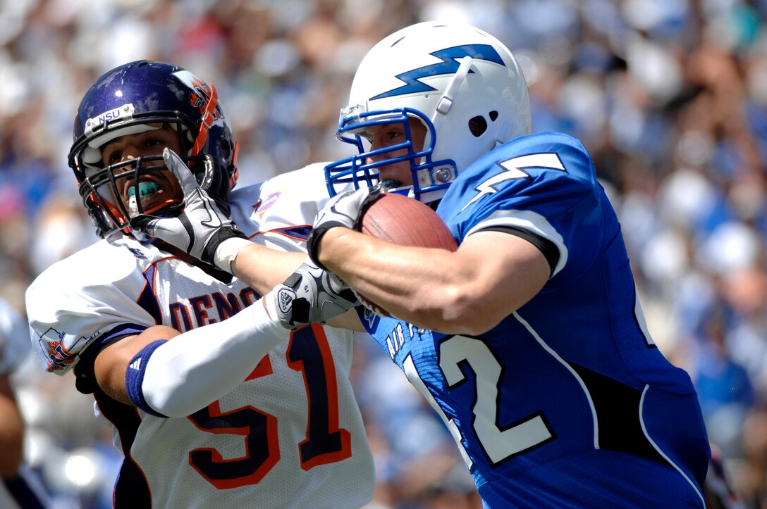 Senior running back Jared Tew strongarms Northwestern State linebacker Yaser Elqutub in the Falcons' season opener against the Demons at Falcon Stadium Sept. 4, 2010. Air Force defeated the Demons, 65-21. Tew, a native of Park City, Utah, had 13 rushes for 65 yards. (U.S. Air Force photo/Mike Kaplan)