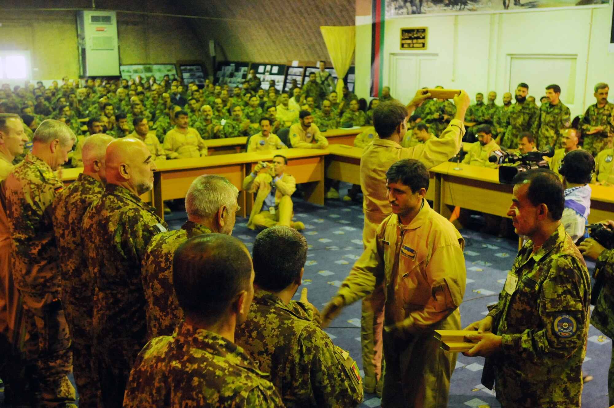 100904-N-6031Q-015 KABUL, Afghanistan -Afghan Air Force personnel are welcomed back home during a ceremony in the conference center of the AAF base in Kabul on Sep. 4, 2010 after providing flood relief to the neighboring country of Pakistan. Over the last 27 days, members of the AAF have been carrying out lifesaving humanitarian missions in Pakistan, demonstrating their strong operational capabilities. (US Navy photo by Mass Communication Specialist 2nd Class David Quillen/ RELEASED).