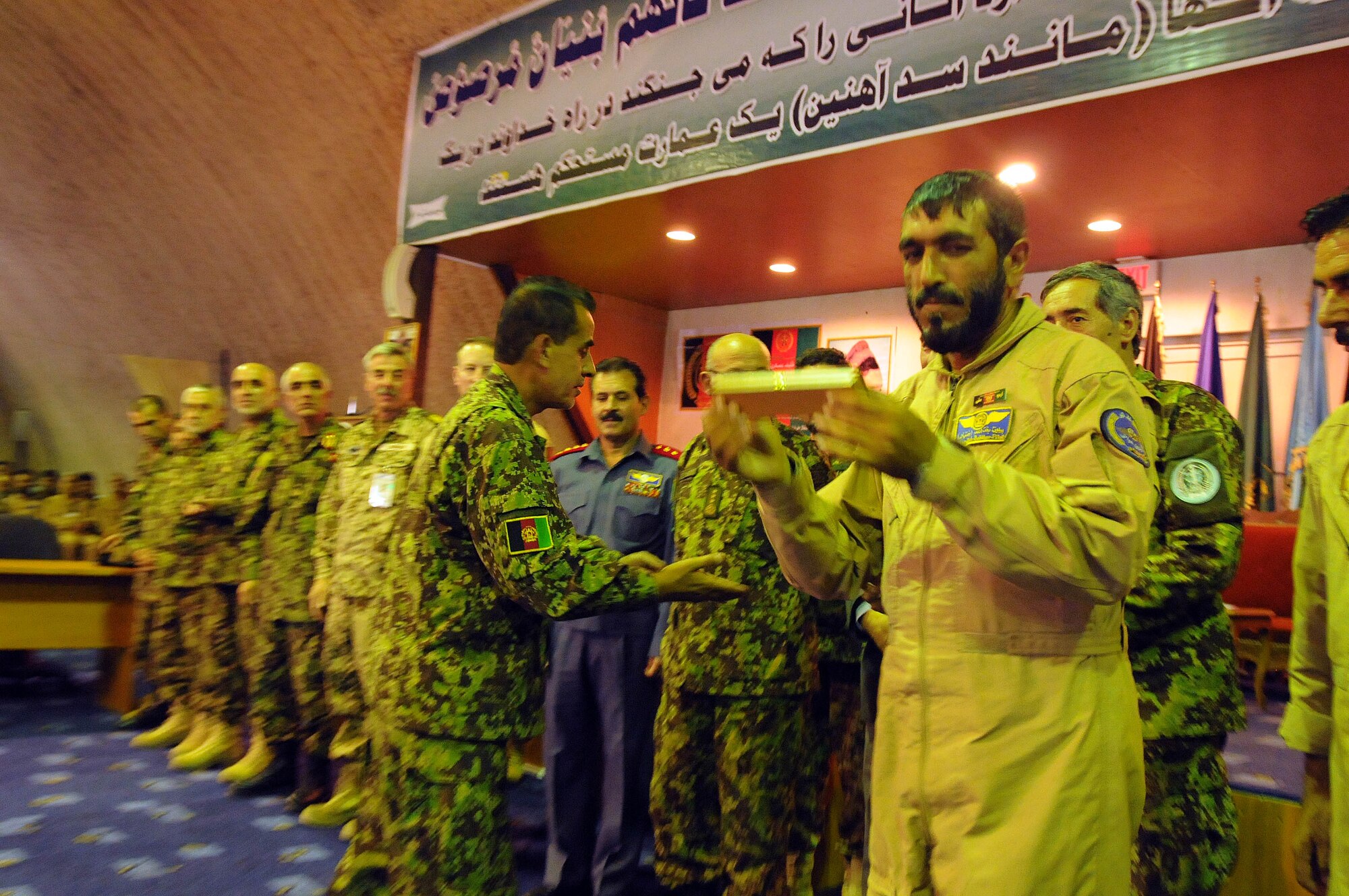 100904-N-6031Q-013 KABUL, Afghanistan -Afghan Air Force personnel are welcomed back home during a ceremony in the conference center of the AAF base in Kabul on Sep. 4, 2010 after providing flood relief to the neighboring country of Pakistan. Over the last 27 days, members of the AAF have been carrying out lifesaving humanitarian missions in Pakistan, demonstrating their strong operational capabilities. (US Navy photo by Mass Communication Specialist 2nd Class David Quillen/ RELEASED).