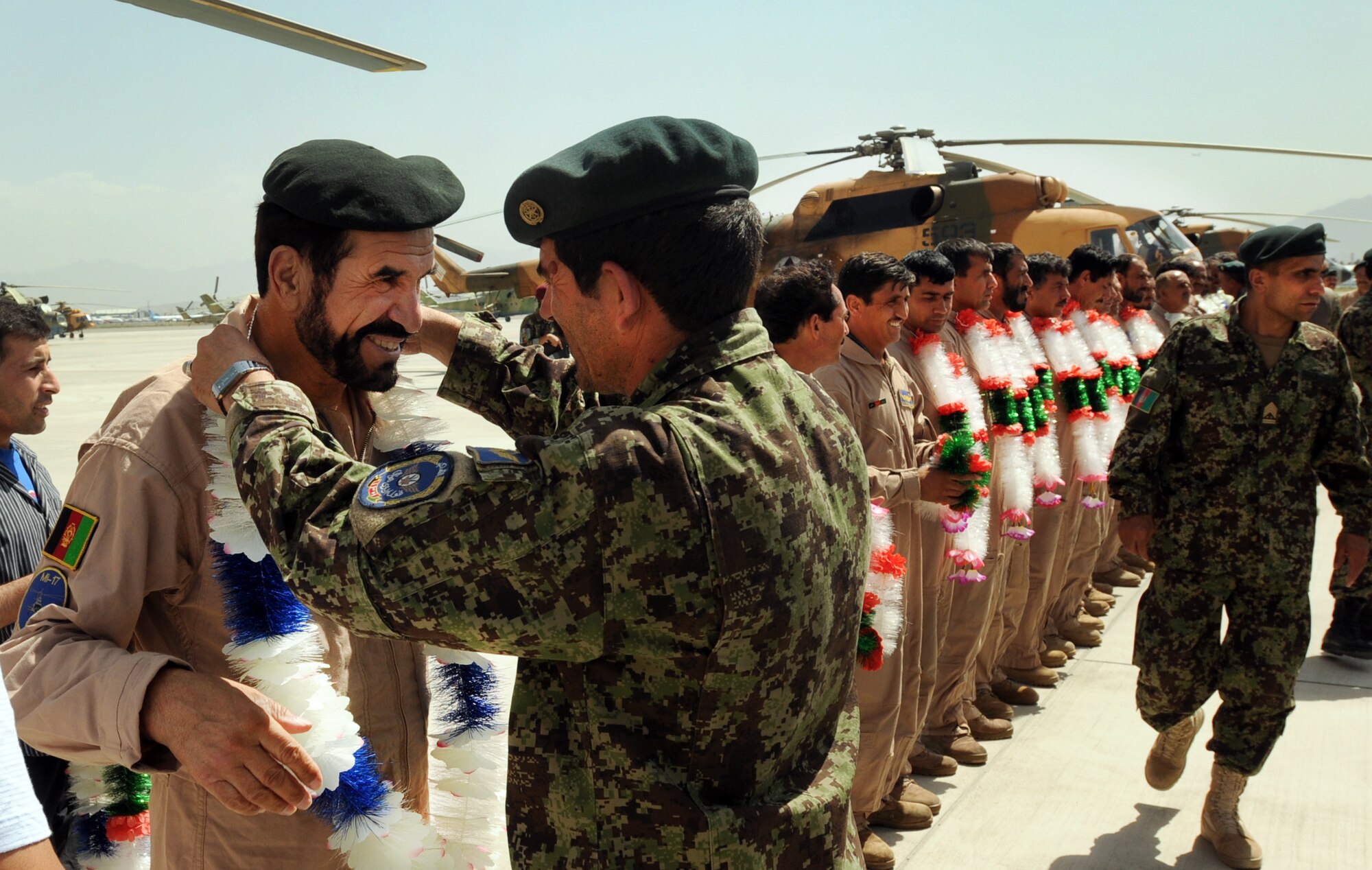 100904-N-6031Q-009 KABUL, Afghanistan -Brig. Gen. Barat, Kabul Air Wing Commander is welcomed back home along with Afghan Air Force personnel on the flight line of the AAF base in Kabul on Sep. 4, 2010 after providing flood relief to the neighboring country of Pakistan. Over the last 27 days, members of the AAF have been carrying out lifesaving humanitarian missions in Pakistan, demonstrating their strong operational capabilities. (US Navy photo by Mass Communication Specialist 2nd Class David Quillen/ RELEASED).