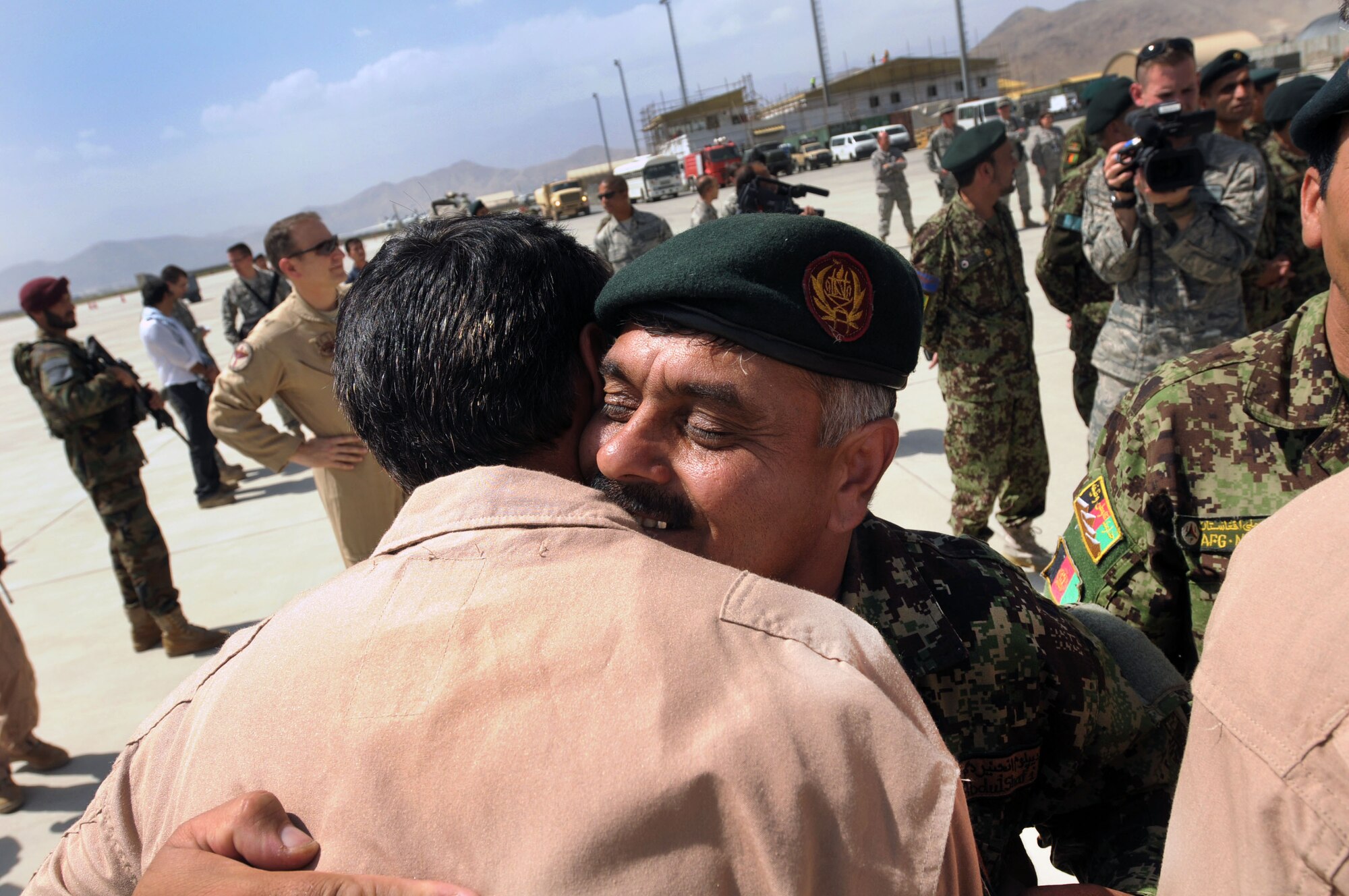100904-N-6031Q-008 KABUL, Afghanistan -Afghan Air Force personnel are welcomed back home on the flight line of the AAF base in Kabul on Sep. 4, 2010 after providing flood relief to the neighboring country of Pakistan. Over the last 27 days, members of the AAF have been carrying out lifesaving humanitarian missions in Pakistan, demonstrating their strong operational capabilities. (US Navy photo by Mass Communication Specialist 2nd Class David Quillen/ RELEASED).