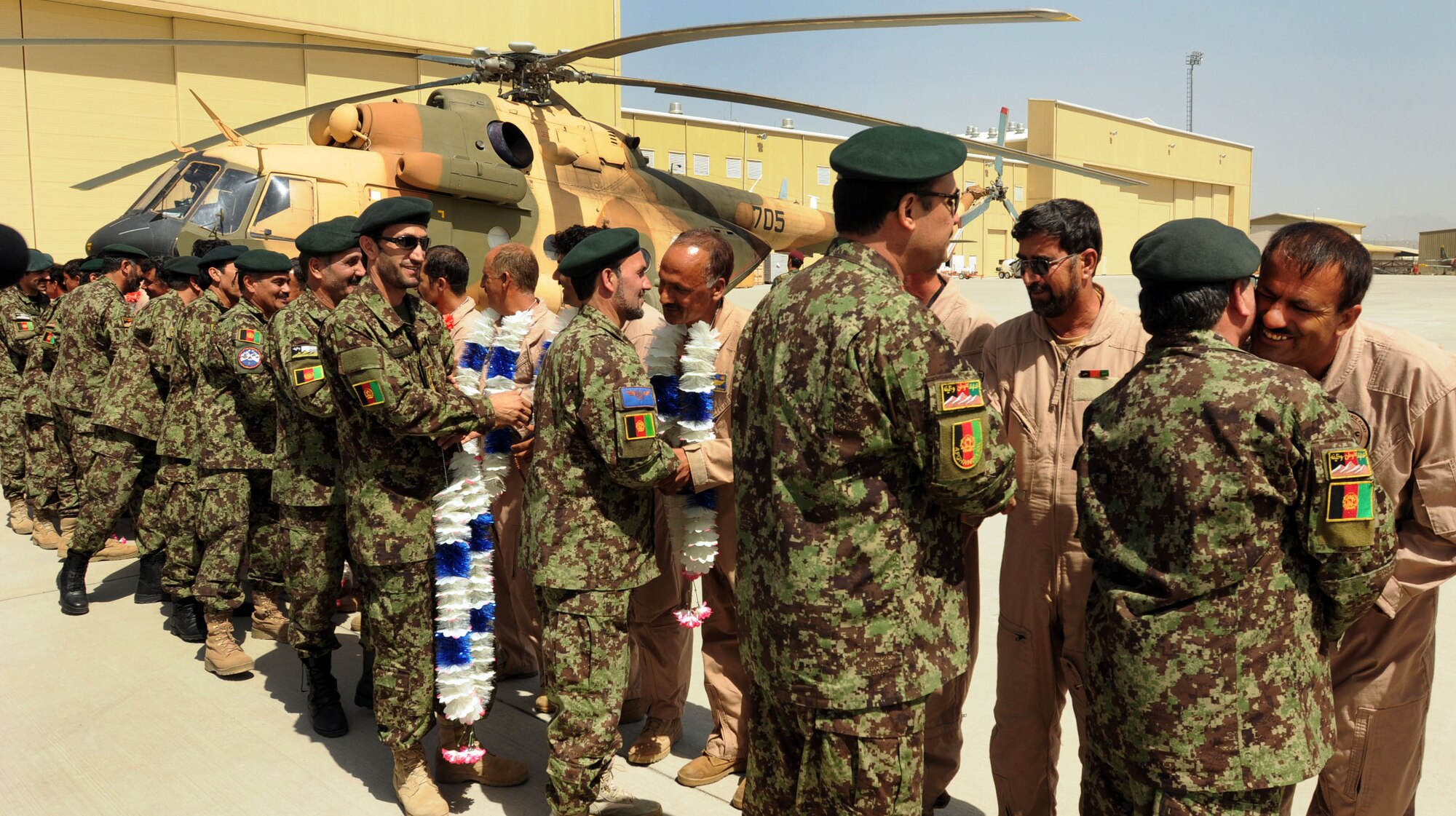 100904-N-6031Q-007 KABUL, Afghanistan -Afghan Air Force personnel are welcomed back home on the flight line of the AAF base in Kabul on Sep. 4, 2010 after providing flood relief to the neighboring country of Pakistan. Over the last 27 days, members of the AAF have been carrying out lifesaving humanitarian missions in Pakistan, demonstrating their strong operational capabilities. (US Navy photo by Mass Communication Specialist 2nd Class David Quillen/ RELEASED).