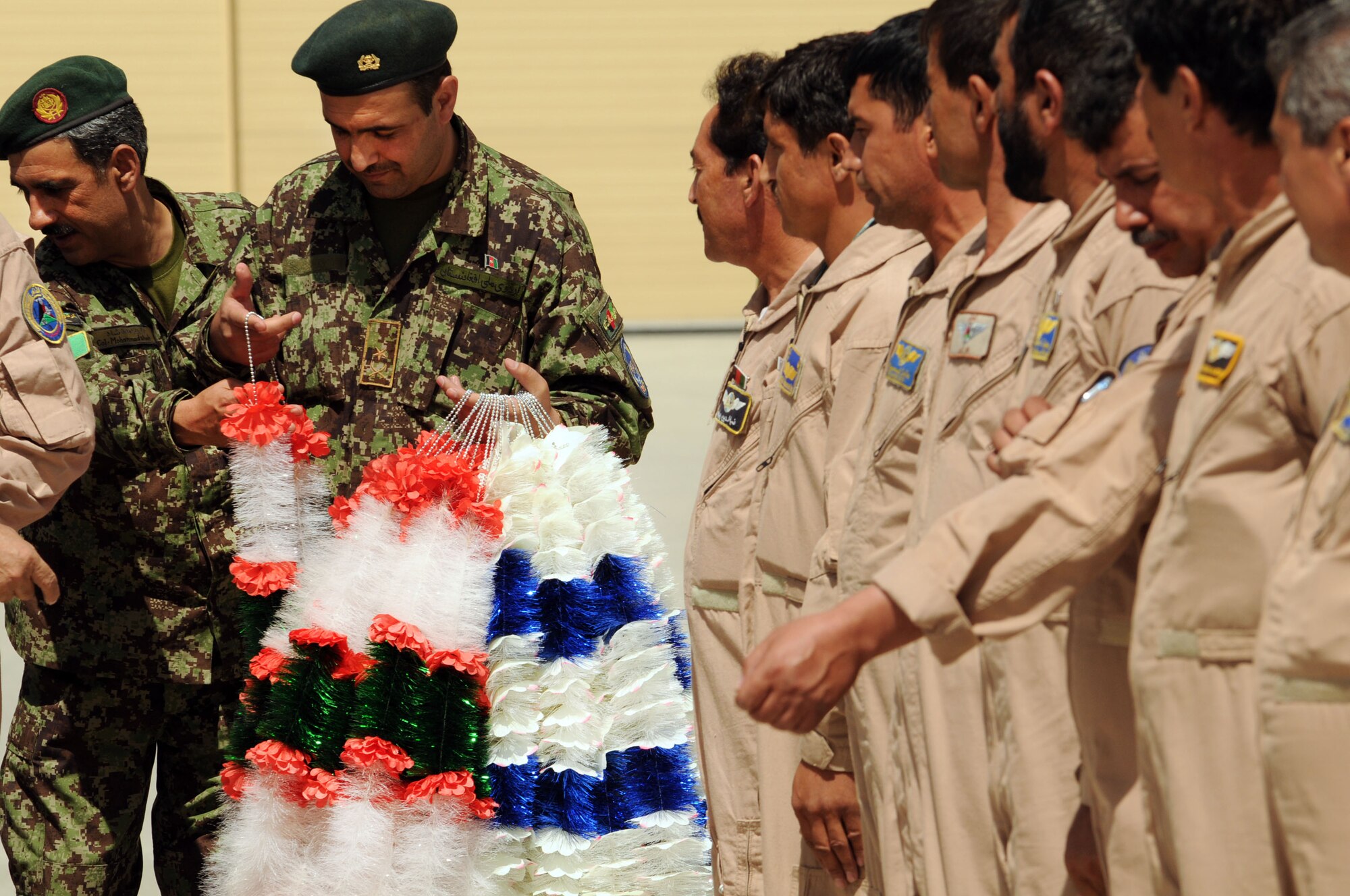 100904-N-6031Q-005 KABUL, Afghanistan -Afghan Air Force personnel are welcomed back home on the flight line of the AAF base in Kabul on Sep. 4, 2010 after providing flood relief to the neighboring country of Pakistan. Over the last 27 days, members of the AAF have been carrying out lifesaving humanitarian missions in Pakistan, demonstrating their strong operational capabilities. (US Navy photo by Mass Communication Specialist 2nd Class David Quillen/ RELEASED).