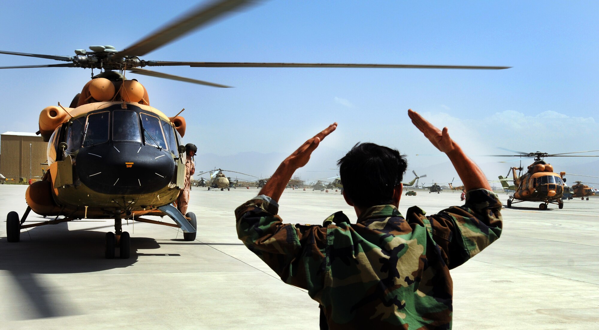 100904-N-6031Q-001 KABUL, Afghanistan -Afghan Air Force personnel are welcomed back home on the flight line of the AAF base in Kabul on Sep. 4, 2010 after providing flood relief to the neighboring country of Pakistan. Over the last 27 days, members of the AAF have been carrying out lifesaving humanitarian missions in Pakistan, demonstrating their strong operational capabilities. (US Navy photo by Mass Communication Specialist 2nd Class David Quillen/ RELEASED).