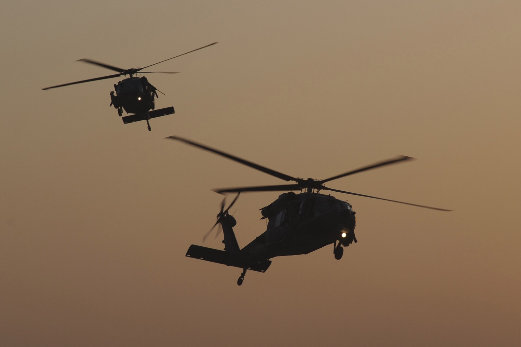 Two HH-60G Pave Hawk Helicopters, flown by Airmen of the 26th Expeditionary Rescue Squadron, return from a rescue mission on Sept. 2, 2010, at Kandahar Airfield, Afghanistan.  (U.S. Air Force photo by Tech. Sgt. Chad Chisholm/Released)