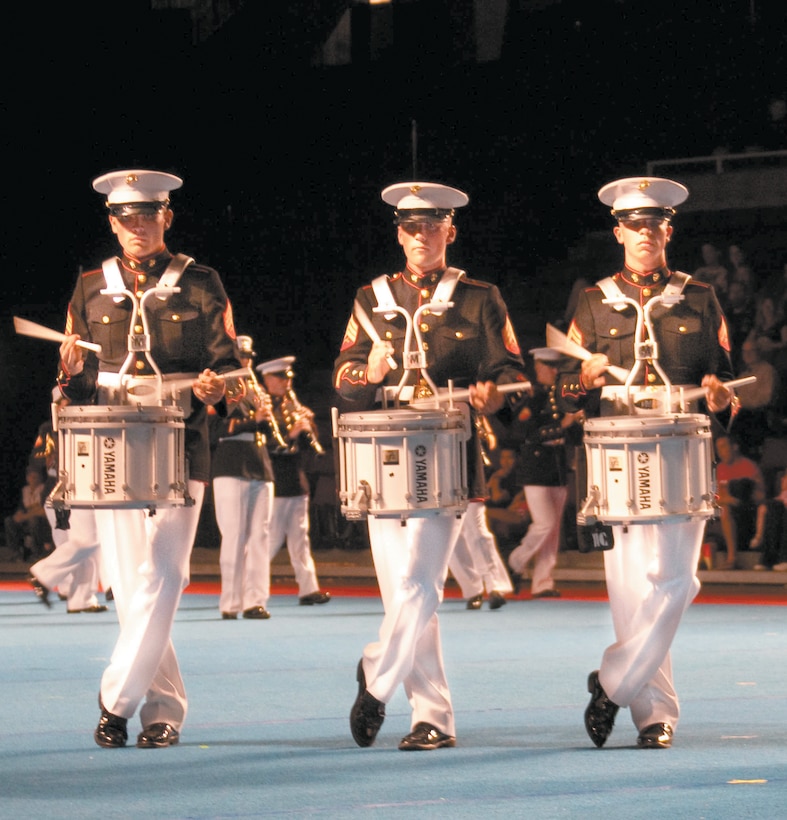 (From left) Sgt. Chad Ranton, Sgt. Matthew R. Cole, Cpl. Britton L. Hartley, percussion specialists, showcase the drum feature during a performance of "Echano" at the Canadian Naval Centennial Tattoo in the Pacific National Exhibition coliseum Saturday. The United States Marine Corps Forces, Pacific ceremonial band performed two field shows celebrating. the 100th anniversary of the Royal Canadian Navy.::r::::n::::r::::n::