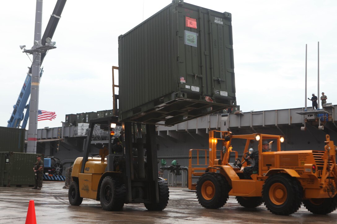 Forklifts are used to transfer supply containers from the White Beach Naval Facility pier to the USS Essex (LHD 2) during the 31st Marine Expeditionary Unit’s on-load, Sept. 6. The 31st MEU is slated to participate in several bilateral training exercises including PHIBLEX 2011 in the Republic of the Philippines and the Korean Incremental Training Program 2011 in the Republic of Korea.