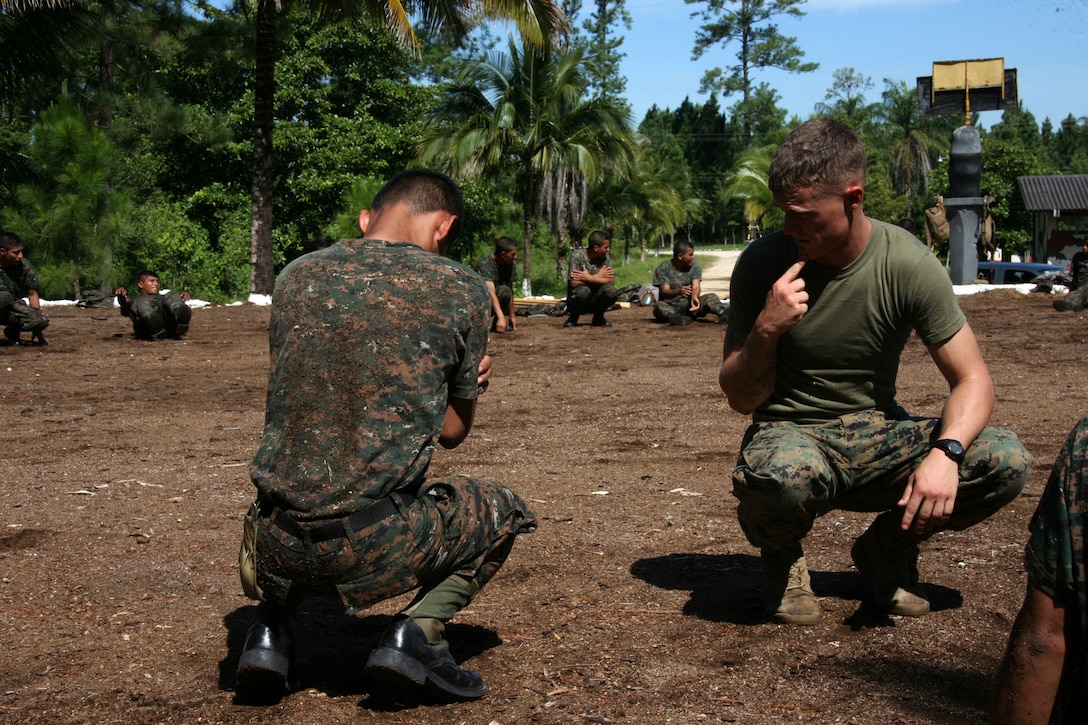 Sgt. Collin E. Lafferty, a Marine Corps Martial Arts instructor with Special-Purpose Marine Air-Ground Task Force Continuing Promise 2010, teaches a Guatemalan Regular Army troop, proper break-fall techniques aboard Poptun Training Camp in Poptun, Guatemala, Sept. 6.  Marine Corps Martial Arts Program instruction was given to the Guatemalan soldiers in relevance to non-lethal weapons techniques for crowd control and rapid and effective distribution of relief supplies in the event of a disaster relief operation.