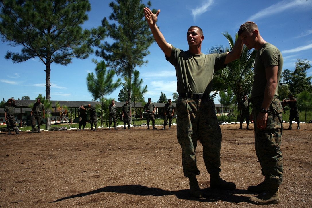 Staff Sgt. Shawn R. Conti and Sgt. Collin E. Lafferty, Marine Corps Martial Arts instructors with Special-Purpose Marine Air-Ground Task Force Continuing Promise 2010, teach Guatemalan Regular Army troops, proper muscular gouging techniques aboard Poptun Training Camp in Poptun, Guatemala, Sept. 6.  Marine Corps Martial Arts Program instruction was given to the Guatemalan soldiers in relevance to non-lethal weapons techniques for crowd control and rapid and effective distribution of relief supplies in the event of a disaster relief operation.