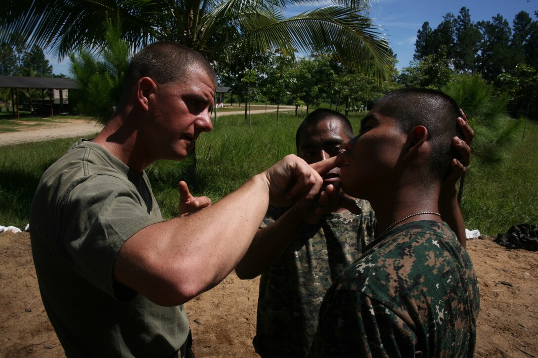 Staff Sgt. Shawn R. Conti, a Marine Corps Martial Arts instructor with Special-Purpose Marine Air-Ground Task Force Continuing Promise 2010, teaches Guatemalan Regular Army troops, proper muscular gouging techniques aboard Poptun Training Camp in Poptun, Guatemala, Sept. 6.  Marine Corps Martial Arts Program instruction was given to the Guatemalan soldiers in relevance to non-lethal weapons techniques for crowd control and rapid and effective distribution of relief supplies in the event of a disaster relief operation.