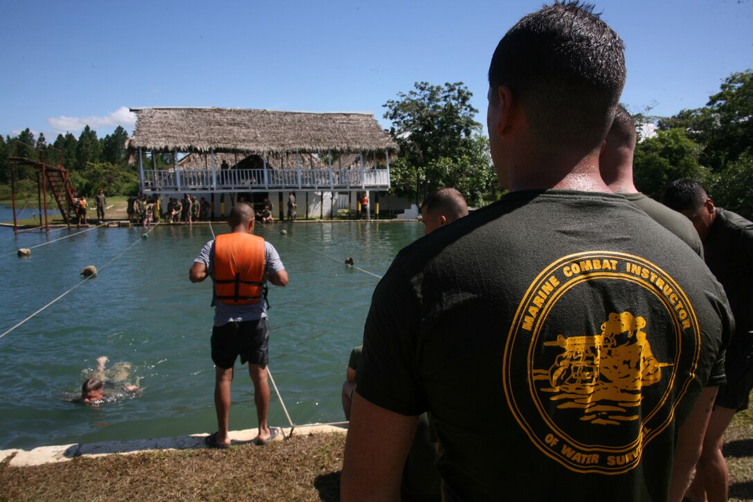 A Marine Combat Instructor of Water Survival observes as U.S. Marines practice water survival aboard Poptun Training Camp in Poptun, Guatemala, Sept. 8.  From Sept. 5-12, Guatemalan Army Special Forces soldiers or "Kaibiles" delivered a package of training exercises for Marines of Special-Purpose Marine Air-Ground Task Force Continuing Promise 2010 to give them a sense of how the elite Guatemalan Special Forces soldiers train on a daily basis.