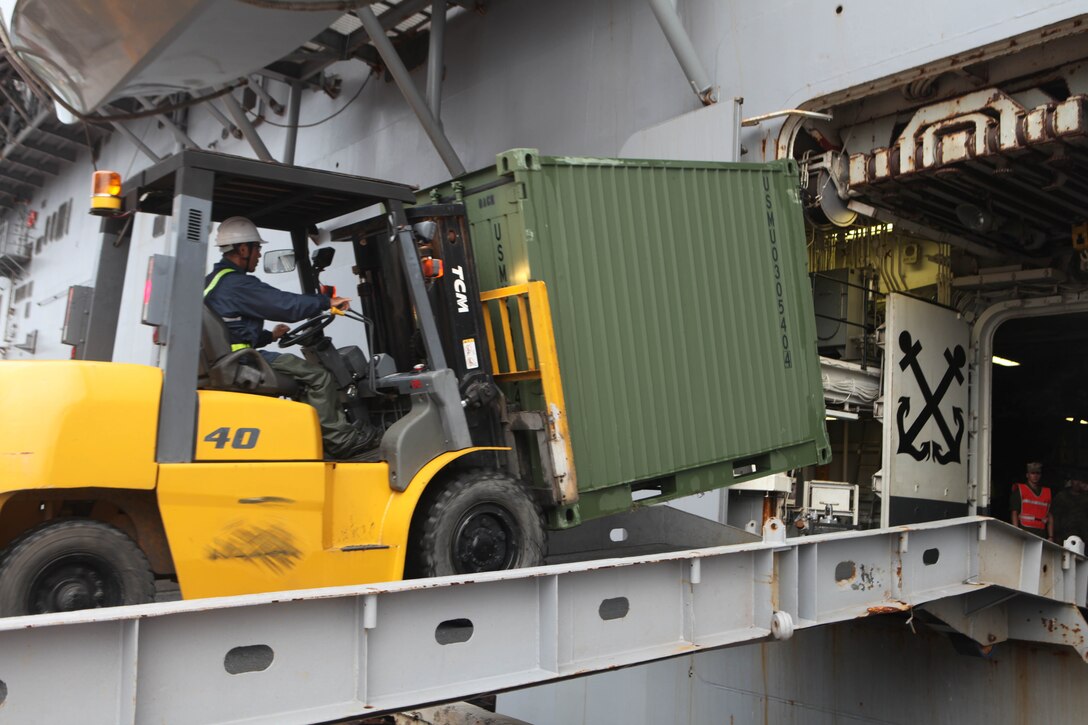 A forklift is used to transfer supply containers from the White Beach Naval Facility pier to the USS Essex (LHD 2) during the 31st Marine Expeditionary Unit’s on-load, Sept. 6. The 31st MEU is slated to participate in several bilateral training exercises including PHIBLEX 2011 in the Republic of the Philippines and the Korean Incremental Training Program 2011 in the Republic of Korea.