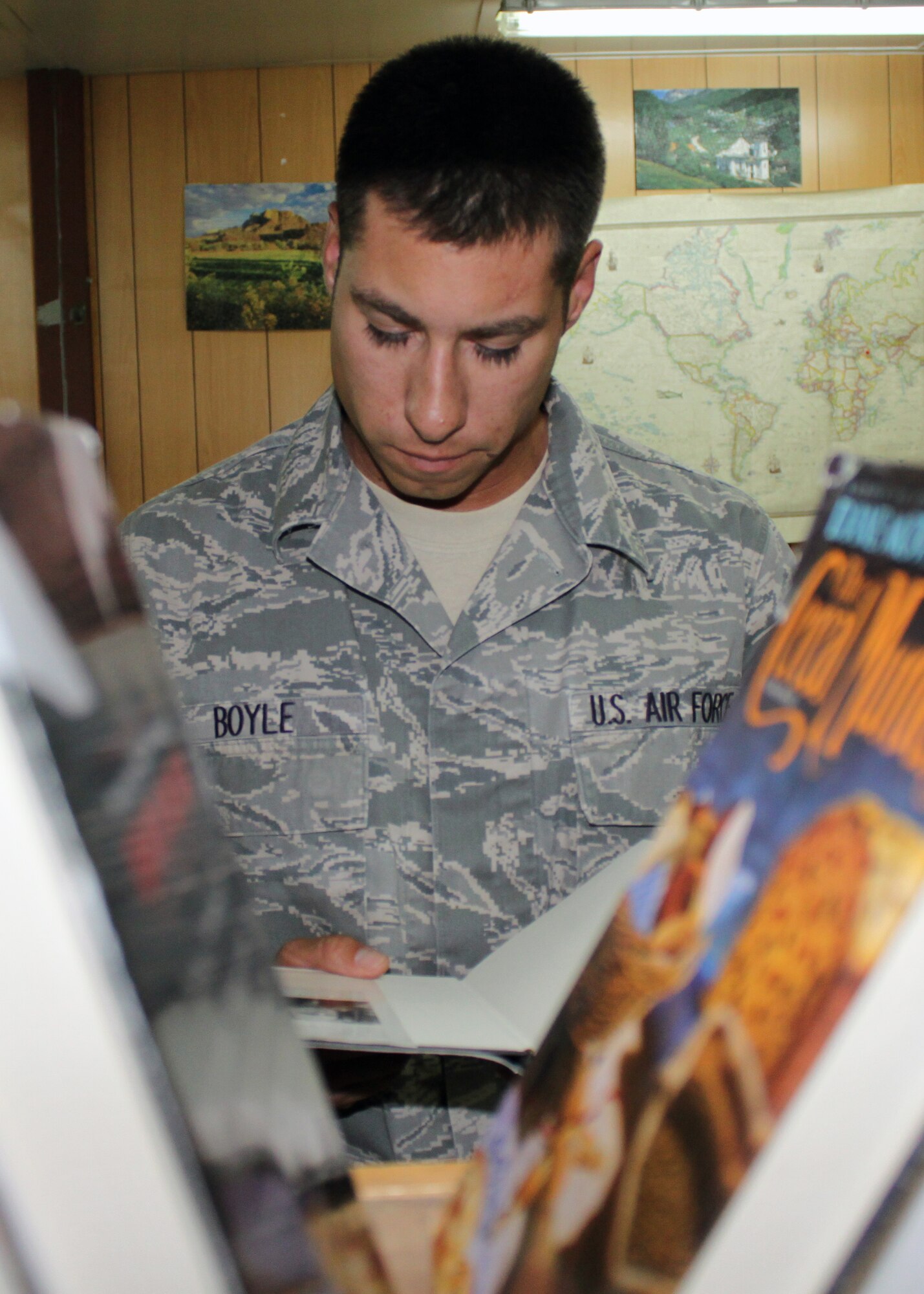 Tech. Sgt. Nick Boyle, 332nd Expeditionary Force Support Squadron NCO in charge of recreation, takes a look at the plot description of a book he will borrow at the Learning Resource Center Sept. 2, 2010, Joint Base Balad, Iraq.  From fun reading to college education, the LRC helps make the deployed warfighter into smarter, better warfighters. Sergeant Boyle is a native of Chattanooga, Tenn., deployed from Shaw Air Force Base, S.C. (U.S. Air Force photo/Tech. Sgt. Stacy Fowler)