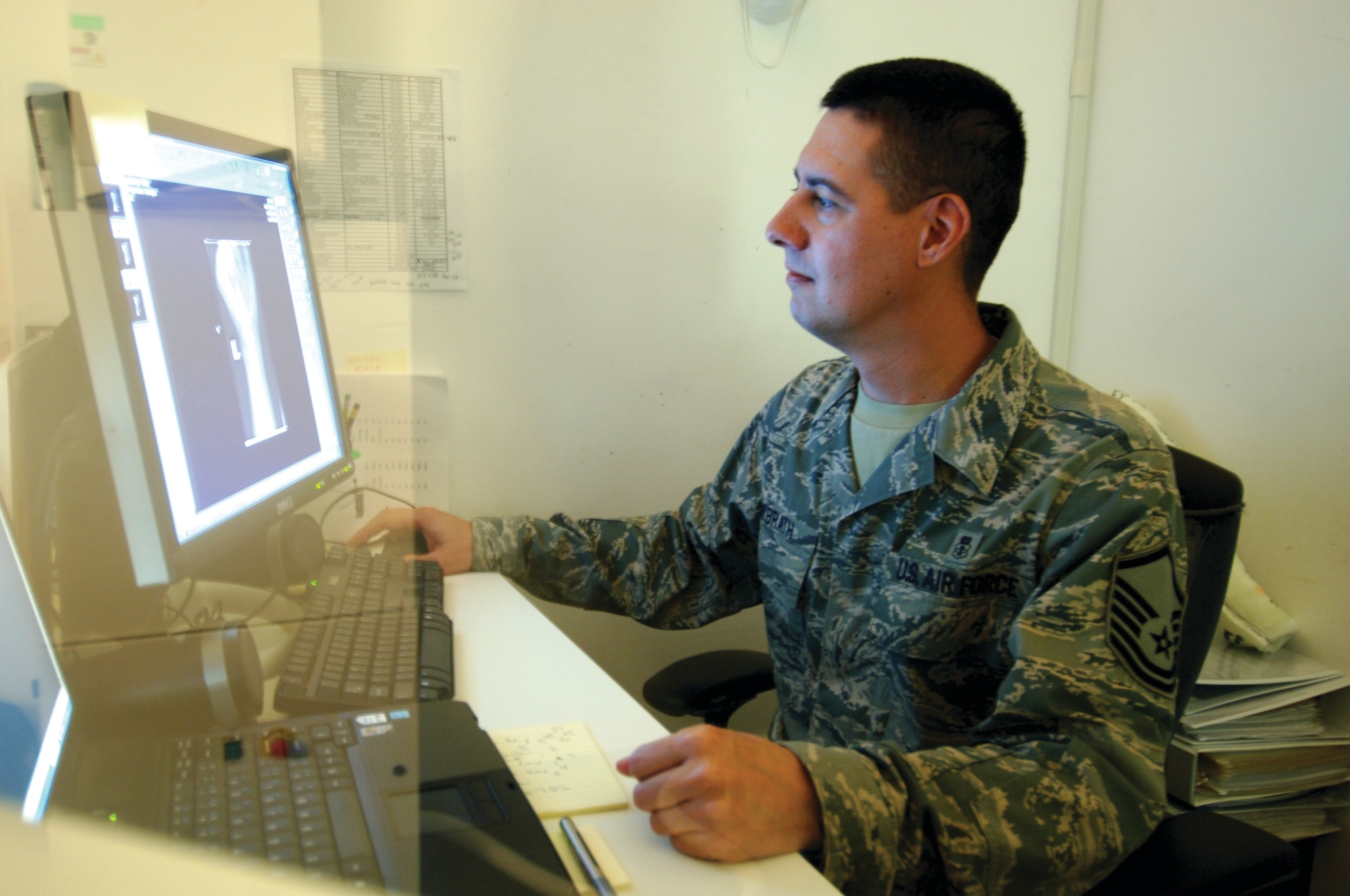 Master Sgt. Bruce Milbrath, 379th EMDG, looks over a patient’s hand X-ray for any signs of fractures.  (U.S. Air Force photo/Tech. Sgt. Kimberly Spinner) 