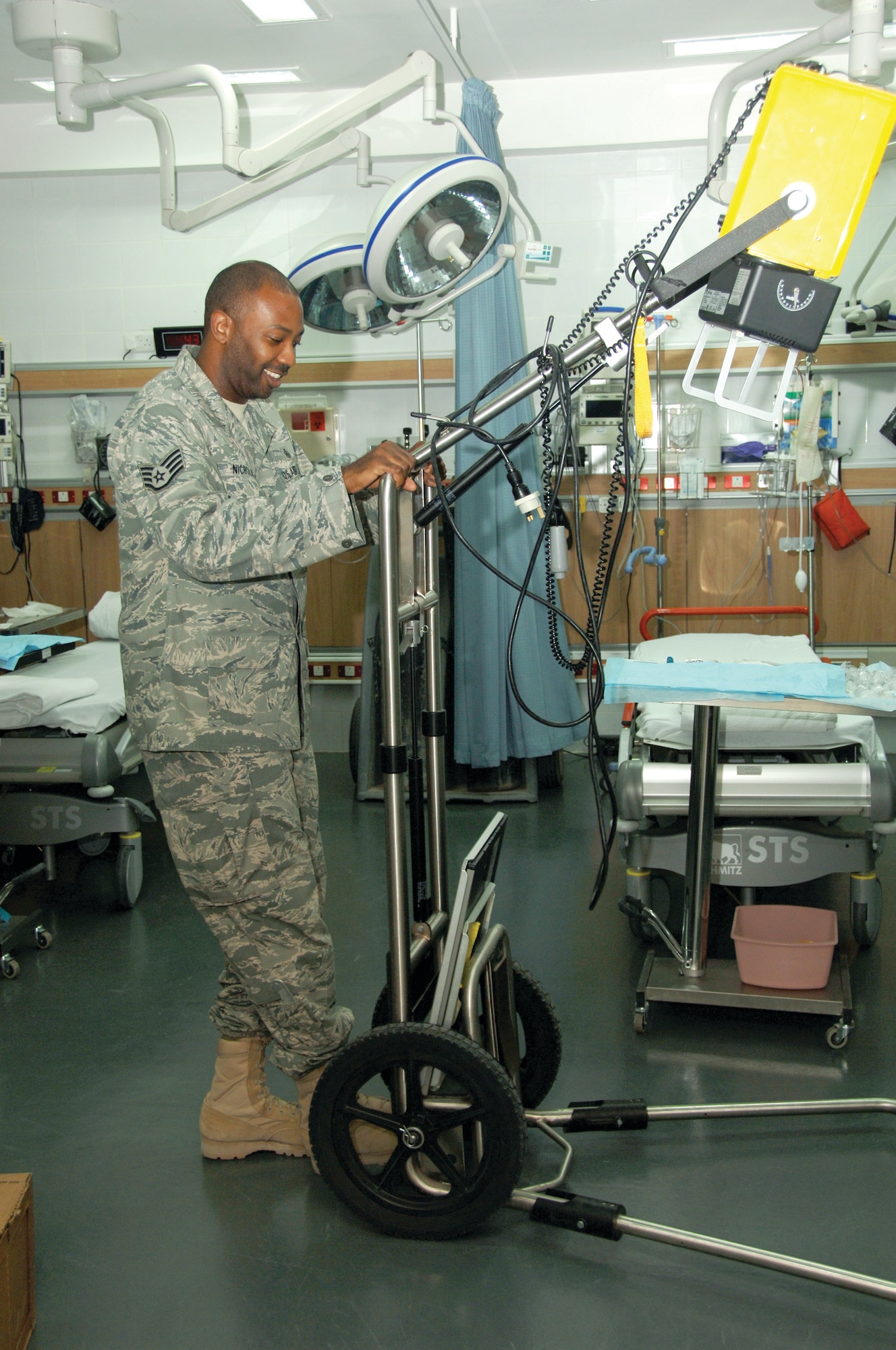 Staff Sgt. Jahmal Nicholas, 379th EMDG, displays an older model portable X-ray machine. He says the machine is still in good condition.(U.S. Air Force photo/Tech. Sgt. Kimberly Spinner)
