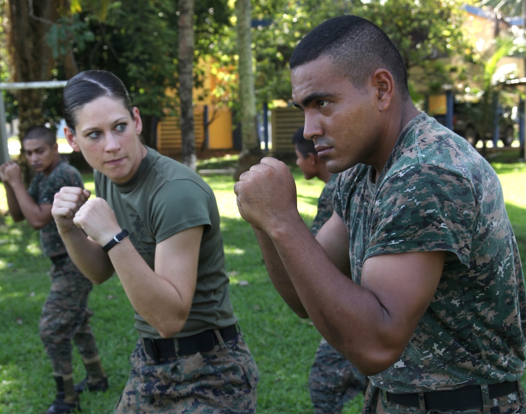 First Lt. Jessica M. Weinbrenner, the training officer with Marine Air Control Squadron 2, Command Element of Special-Purpose Marine Air-Ground Task Force Continuing Promise 2010, watches as a Guatemalan Marine prepares to execute a U.S. Marine Corps martial arts rear-hand punch, Sept. 7, at Puerto Santo Tomas de Castilla Naval Base in Guatemala. Marines with Special-Purpose Marine Air-Ground Task Force Continuing Promise 2010 taught Marine Corps martial arts techniques to Guatemalan Marines for six days. Marines with CP10 are currently deployed to the Caribbean, Central and South America conducting subject-matter expert exchanges and providing humanitarian civic assistance to host nations.