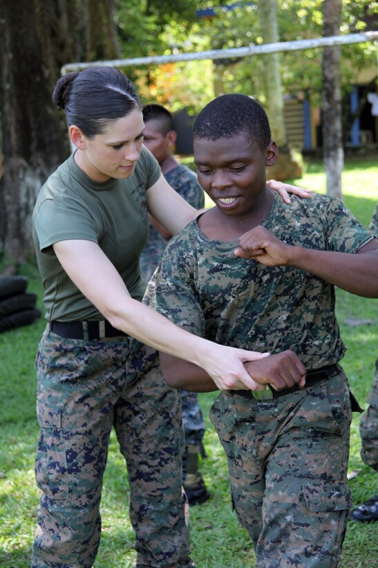 First Lt. Jessica M. Weinbrenner, the training officer with Marine Air Control Squadron 2, Command Element of Special-Purpose Marine Air-Ground Task Force Continuing Promise 2010, shows a Guatemalan Marine how to execute a U.S. Marine Corps martial arts hook, Sept. 7, at Puerto Santo Tomas de Castilla Naval Base in Guatemala. Marines with Special-Purpose Marine Air-Ground Task Force Continuing Promise 2010 taught Marine Corps martial arts techniques to Guatemalan Marines for six days. Marines with CP10 are currently deployed to the Caribbean, Central and South America conducting subject-matter expert exchanges and providing humanitarian civic assistance to host nations.
