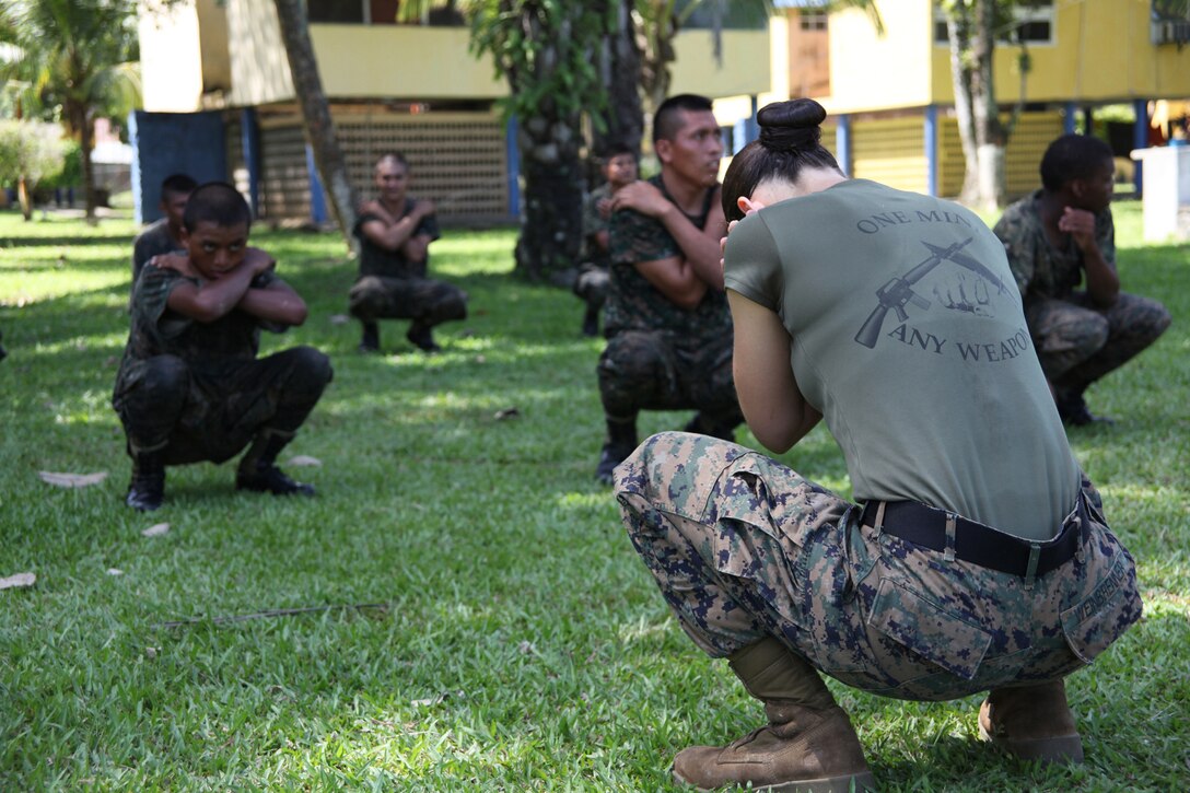 First Lt. Jessica M. Weinbrenner, the training officer with Marine Air Control Squadron 2, Command Element of Special-Purpose Marine Air-Ground Task Force Continuing Promise 2010, prepares to show Guatemalan Marine how to execute a U.S. Marine Corps martial arts back break-fall, Sept. 7, at Puerto Santo Tomas de Castilla Naval Base in Guatemala. Marines with Special-Purpose Marine Air-Ground Task Force Continuing Promise 2010 taught Marine Corps martial arts techniques to Guatemalan Marines for six days. Marines with CP10 are currently deployed to the Caribbean, Central and South America conducting subject-matter expert exchanges and providing humanitarian civic assistance to host nations.
