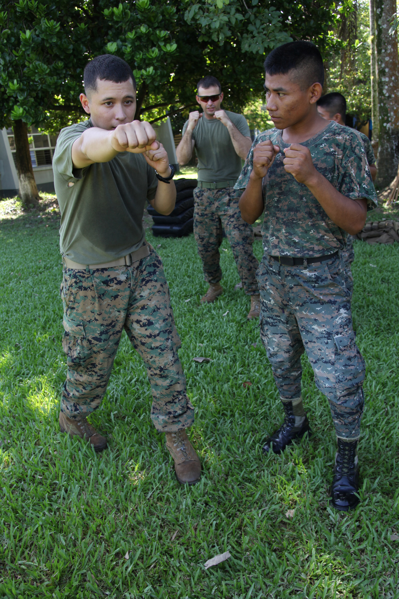 Cpl. Eduardo L. Martin, a radio operator with Company A, 2nd Assault Amphibian Battalion, Ground Combat Element of Special-Purpose Marine Air-Ground Task Force Continuing Promise 2010, shows a Guatemalan Marine a rear-hand punch during U.S. Marine Corps Martial Arts techniques, Sept. 7,  at Puerto Santo Tomas de Castilla Naval Base in Guatemala. Marines with CP10 are currently deployed to the Caribbean, Central and South America conducting subject-matter expert exchanges and providing humanitarian civic assistance to host nations.