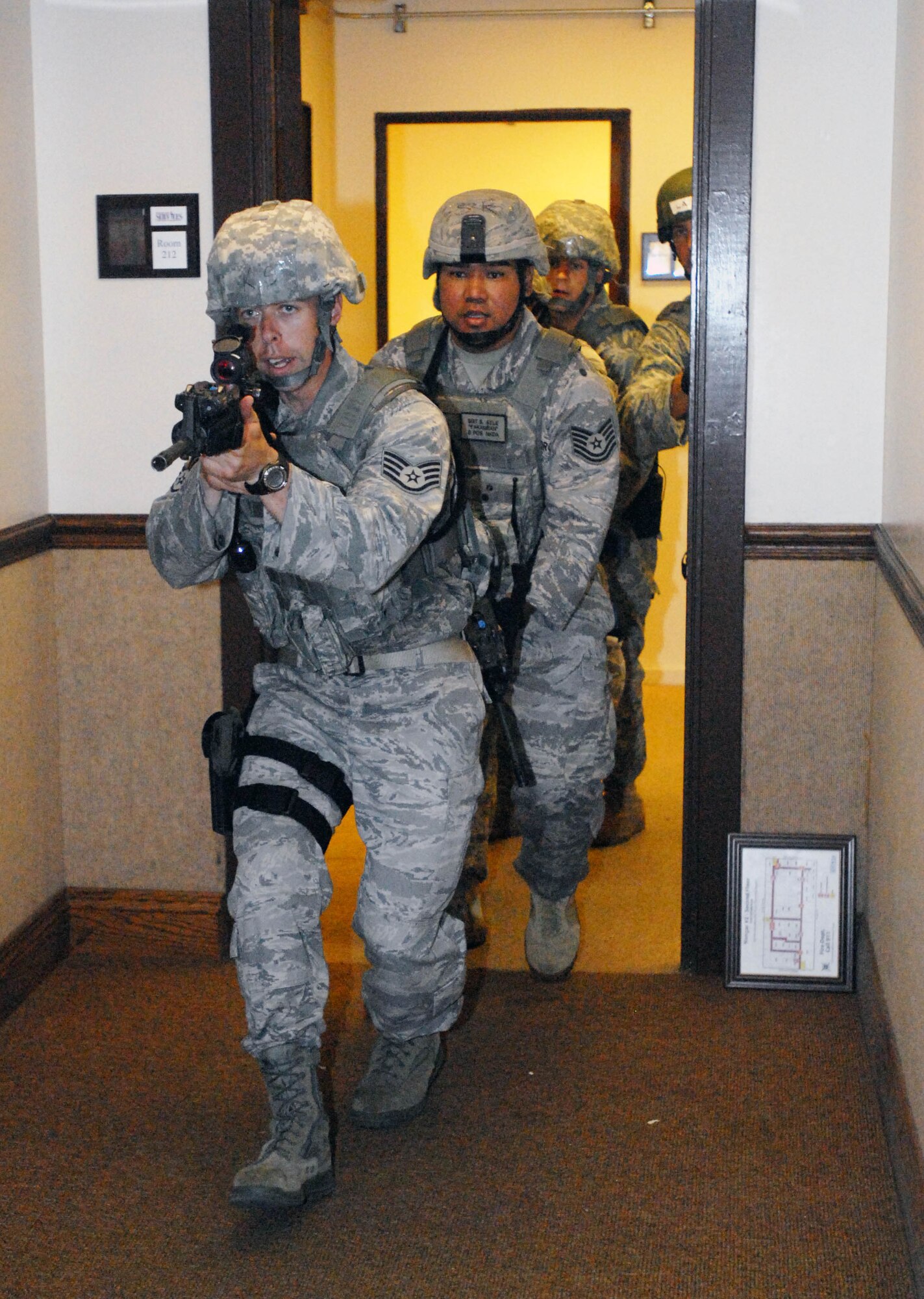 JOINT BASE PEARL HARBOR HICKAM, Hawaii - 647th Security Forces Squadron Airmen practice maneuvering through a building they’re unfamiliar with during a High Risk Response course here, Sept. 2. The active shooter scenario they received is now necessary in part because of the Ft. Hood, Texas, shootings which occurred in November 2009. (U.S. Air Force photo/Staff Sgt. Carolyn Viss) 