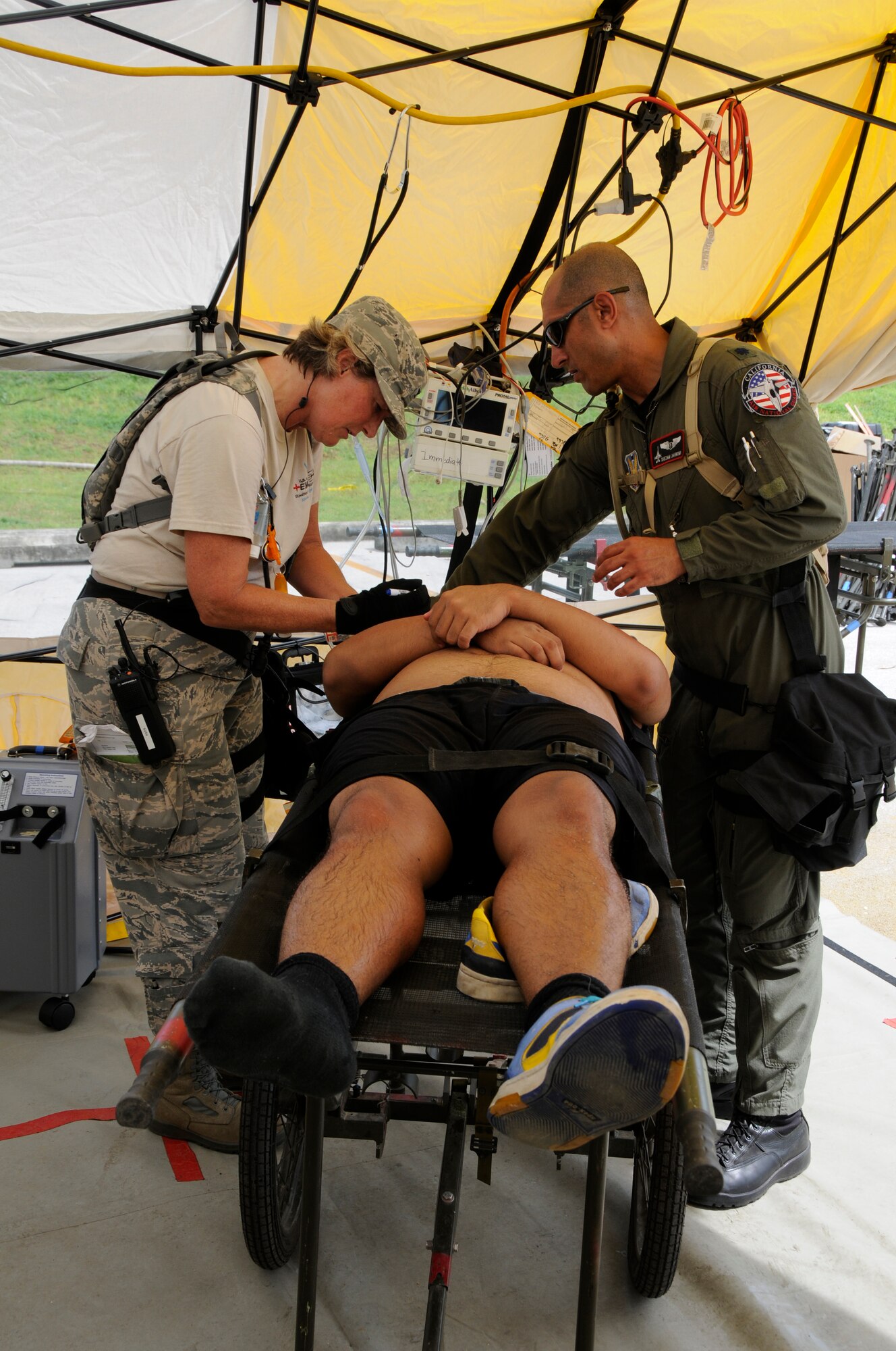 Doctors with the California National Guards Chemical, Biological, Radiological/Nuclear and Explosive Enhanced Force Package (CERFP) team, provide emergency tratement to a victim of a mock parking garage collapse during Vigilant Guard Guam, Aug. 24, 2010. (U.S. Air Force photo by Tech Sgt Charles Vaughn)(released)