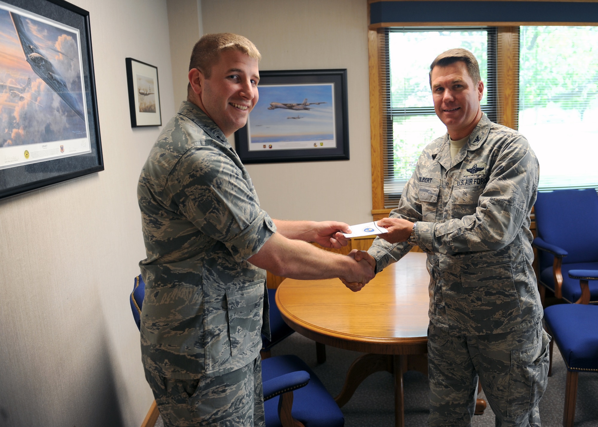 MINOT AIR FORCE BASE, N.D. -- Col. Julian Tolbert, 5th Bomb Wing vice commander, buys the first 2010 Air Force Ball ticket from Capt. Andrew Geer, 5th Security Forces Squadron officer-in-charge of logistics, here Sept. 2. This year’s AF Ball will be held at the Jimmy Doolittle Center on Sept. 25. Please RSVP to the E-Invite no later than Sept. 18. (U.S. Air Force photo by Staff Sgt. Keith Ballard)