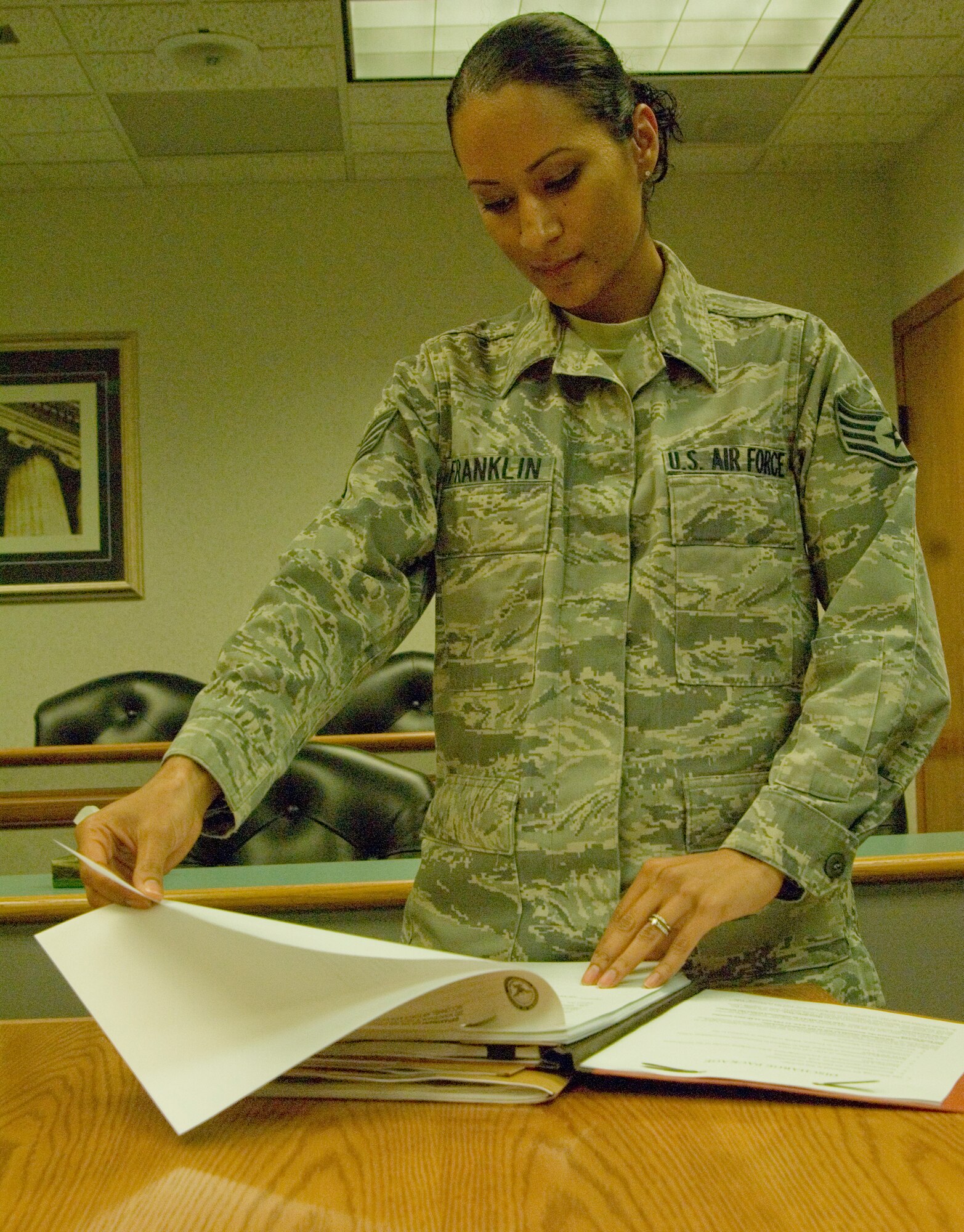 Staff Sgt. Sue-Ann Franklin, 22nd Air Refueling Wing military justice paralegal, reviews formal military discharge paperwork Sept. 2, 2010, McConnell Air Force Base, Kan.  Sergeant Franklin is responsible for aiding with Article 15 punishment actions as well as assisting with other military justice matters at the base legal office. (U.S. Air Force photo/Senior Airman Abigail Klein)