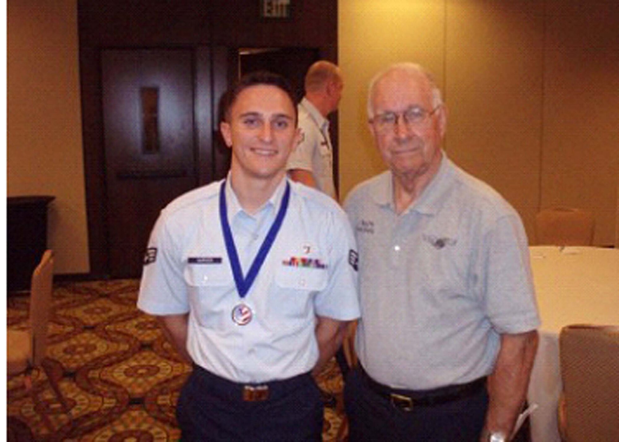 Senior Airman Nicholas Carver stands with Chief Master Sergeant of the Air Force (retired) Sam Parish at the Air Force Sergeants Association annual conference. (Courtesy photo/AFSA)