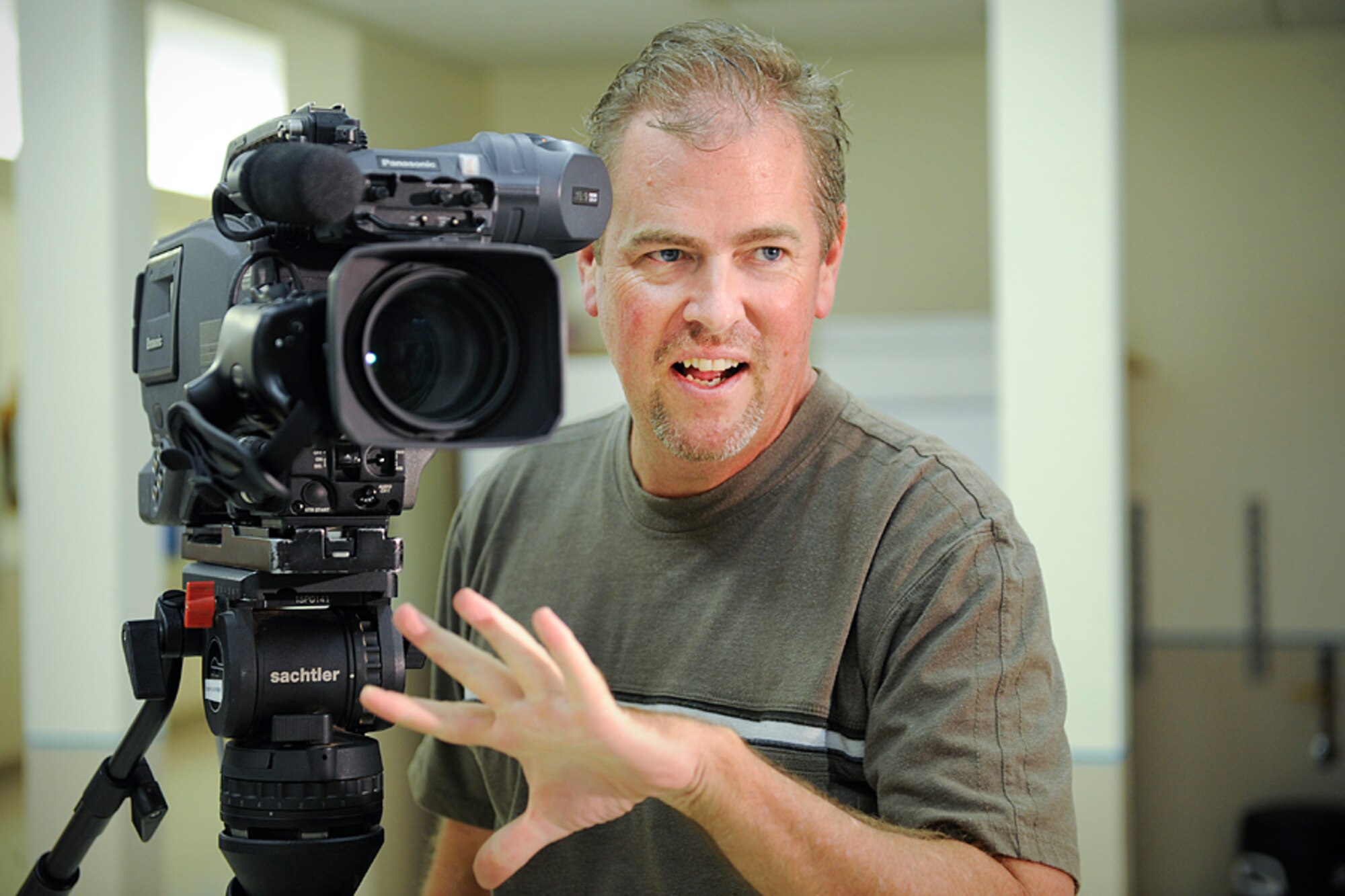 Scott Williams sets up a holiday greetings shot Sept. 7, 2010, during a practice session at the Defense Media Activity – San Antonio headquarters. Mr. Williams, a broadcast specialist with the Joint Hometown News Service, is a member of the European greetings team. (U.S. Air Force photo by Tech. Sgt. Sean Worrell)
