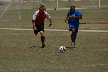 Randolph Air Force Base soccer team plays other intramural teams from other Air Force bases from across the United States. The games were part of 2010 Defender's Cup held at the South Texas Area Regional Soccer Complex in San Antonio, Texas.  Randolph's Abraham Flomo, who scored the game's only two goals, keeps the ball near Cannon's goal. (U.S. Air Force Photo/Brian McGloin)