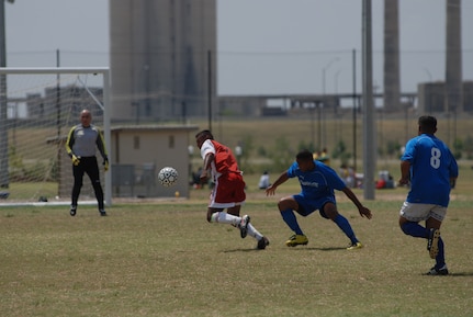 Randolph Air Force Base soccer team plays other intramural teams from other Air Force bases from across the United States. The games were part of 2010 Defender's Cup held at the South Texas Area Regional Soccer Complex in San Antonio, Texas. Alexis Trevor and Eliud Torres prevent a Cannon AFB forward from scoring. Randolph beat Cannon 2-0. (U.S. Air Force Photo/Brian McGloin)