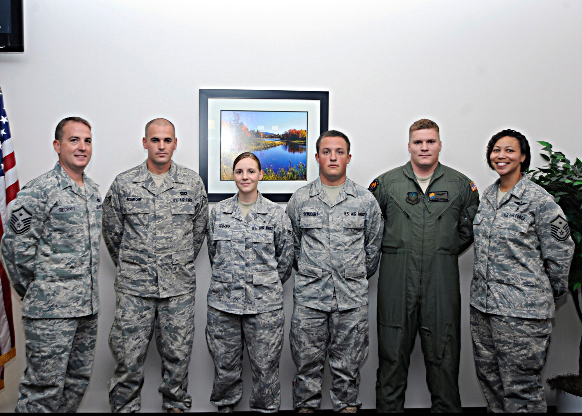 (Left) 1st Sgt. David Becraft, 16th Special Operations Squadron and (right) 1st Sgt. Sheronne King, 27th Special Operations Component Maintenance Squadron, flank Cannon Air Force Base, N.M., Diamond Sharp Airmen Sept. 3 at the Pecos Trail Dining Facility. Airmen 1st Class Daryle Borque, 27th Special Operations Civil Engineer Squadron, Stepanie Todaro, 27th Special Operations Medical Support Squadron  and Matthew Schubert, 27th  Special Operations Aircraft Maintenance Squadron, were recognized for their superior job performance, leadership skills, dress and appearance. (U. S. Air Force photo by Greg Allen)