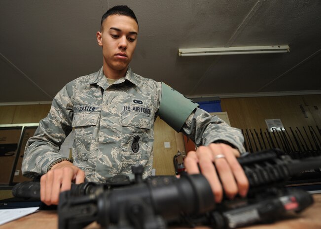 Airman 1st Class Matthew Baxters inspects a M-4 Assault Rifle in the 405th Security Forces Squadron armory Aug. 6. Airman Baxter works as a security forces armorer, who is responsible for the accountability of more than 300 weapons, more than 23,000 rounds and $640,000 in Air Force assets. (Courtesy Photo)
