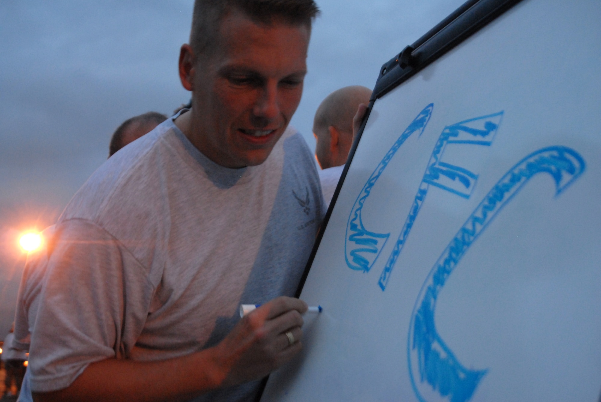 GOODFELLOW AIR FORCE BASE, Texas -- Captain Michael Ingram, 17th Force Support Squadron, draws out a Combined Federal Campaign design prior to the official kick off during the Wing Quarterly Sports Day, Sept. 2. CFC is the world's largest and most successful annual workplace charity campaign, with more than 300 CFC campaigns throughout the country and internationally to help to raise millions of dollars each year. (U.S. Air Force photo/ Senior Airman Tong Duong)